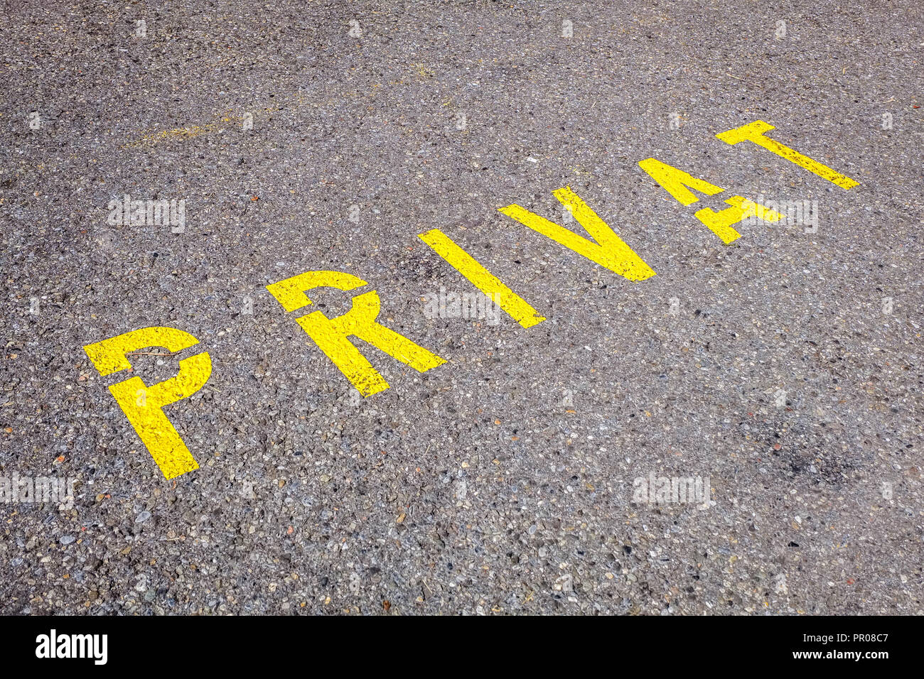 Swiss yellow road marking indicating this is a private parking spot or entrance. It can be used as a photograph that describes modern times Stock Photo