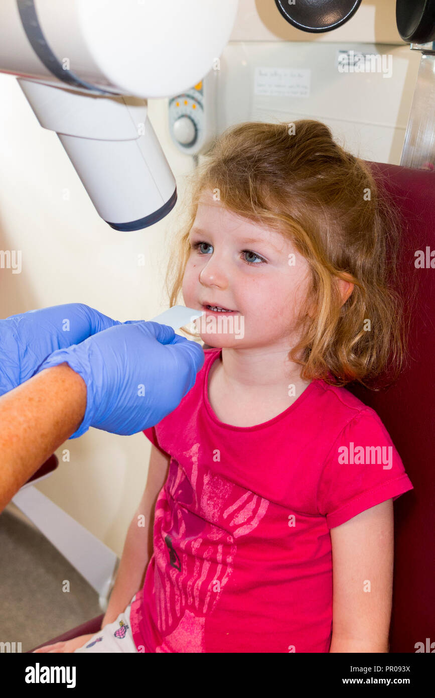 Child aged 4 years about to have a dental xray of her top front tooth