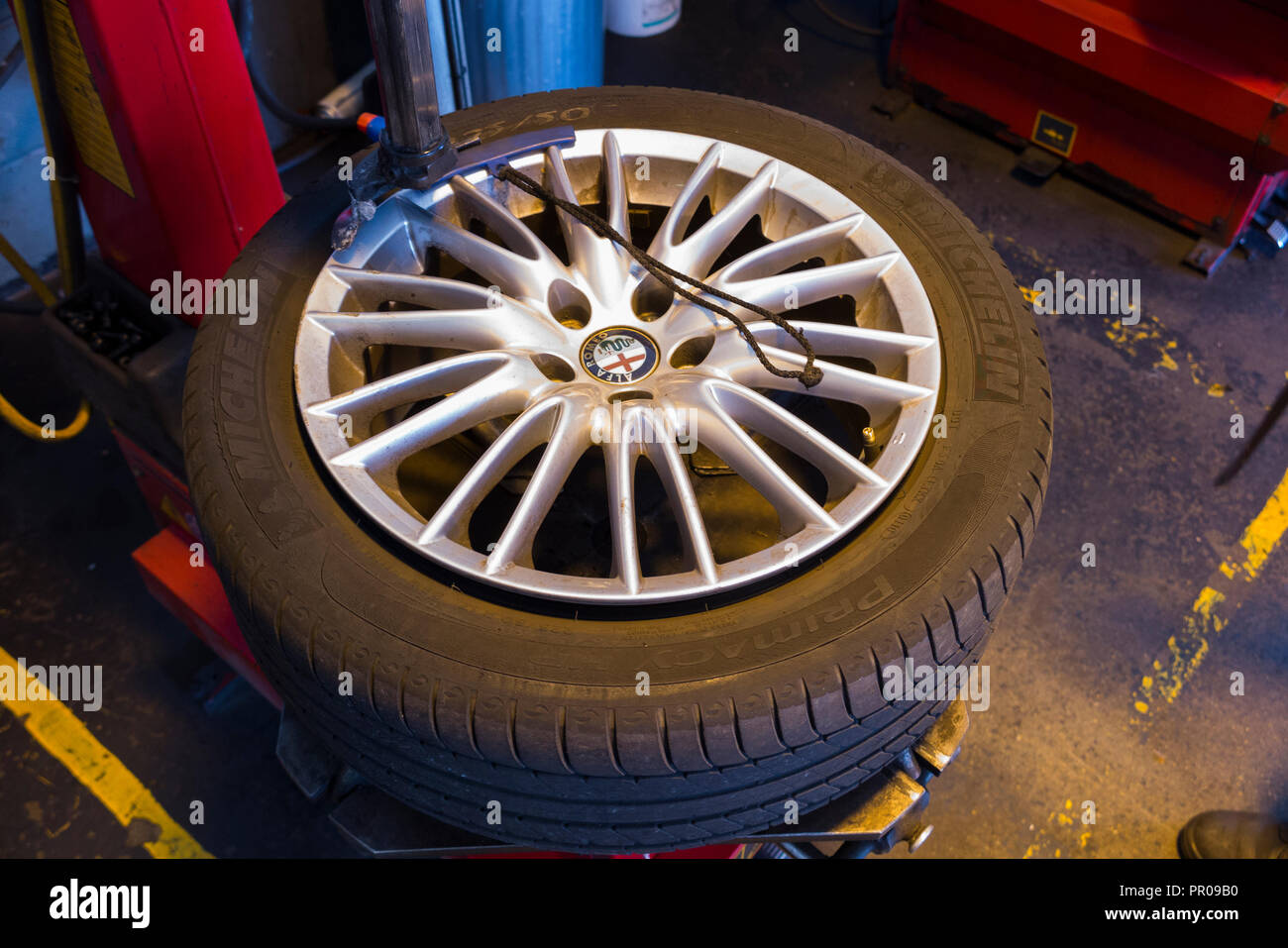 Tyre fitter / mechanic remove / removing / removes / removal of an old