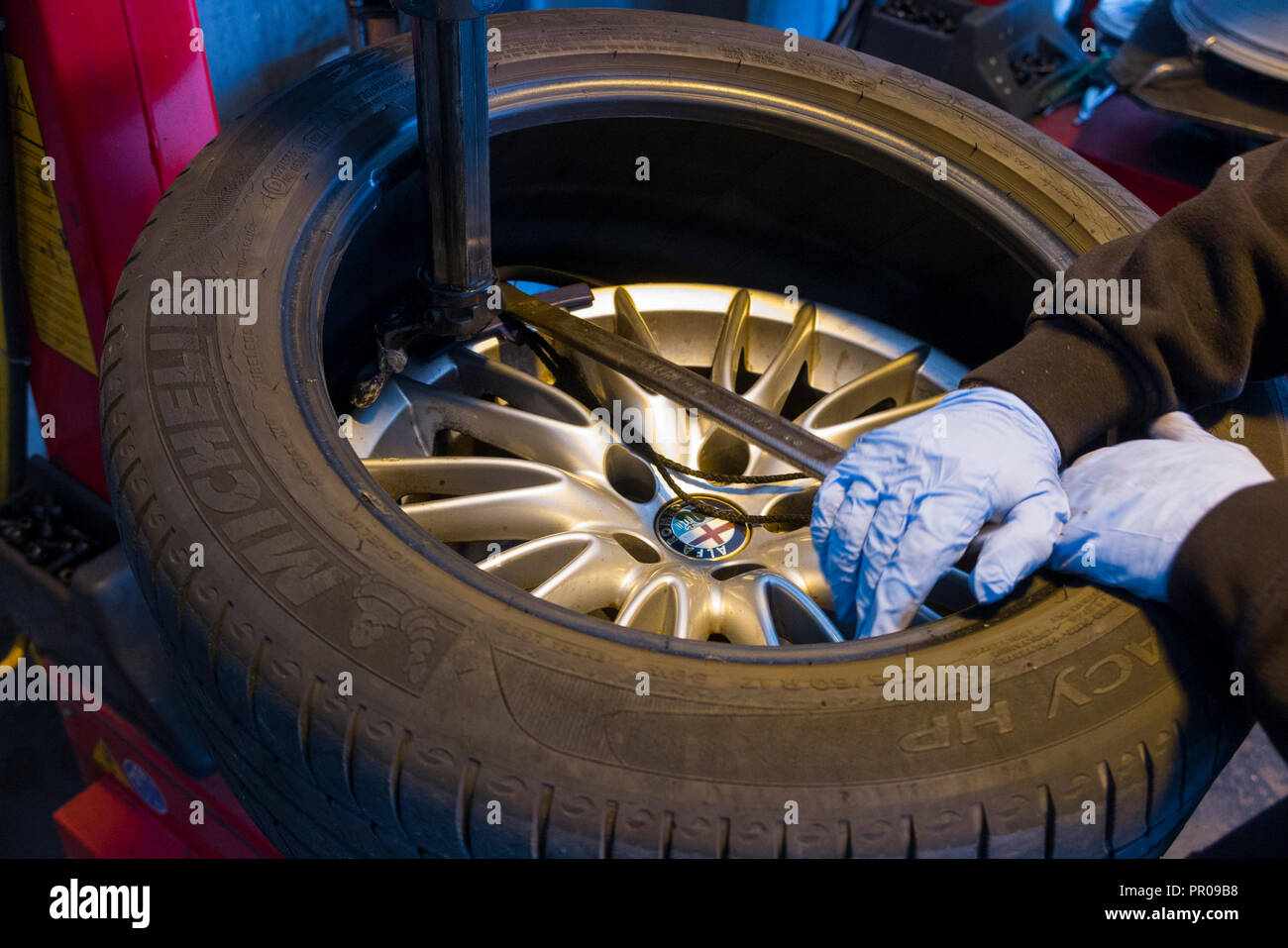 Tyre fitter / mechanic remove / removing / removes / removal of an old