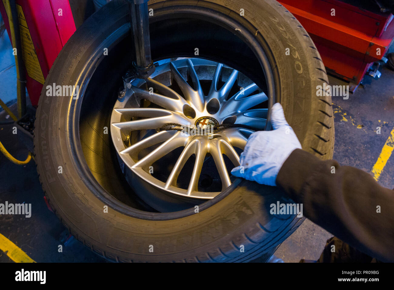 Tyre fitter / mechanic remove / removing / removes / removal of an old