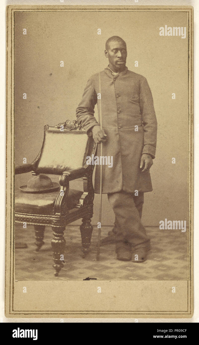 Black soldier standing near chair with hat in seat; Alexander Gardner, American, born Scotland, 1821 - 1882, about 1862 Stock Photo
