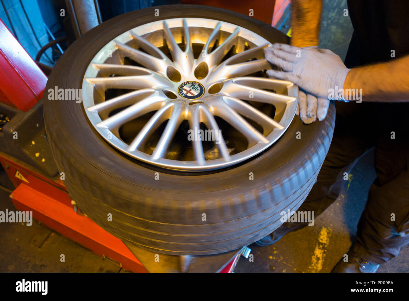 Tyre fitter / mechanic remove / removing / removes / removal of an old