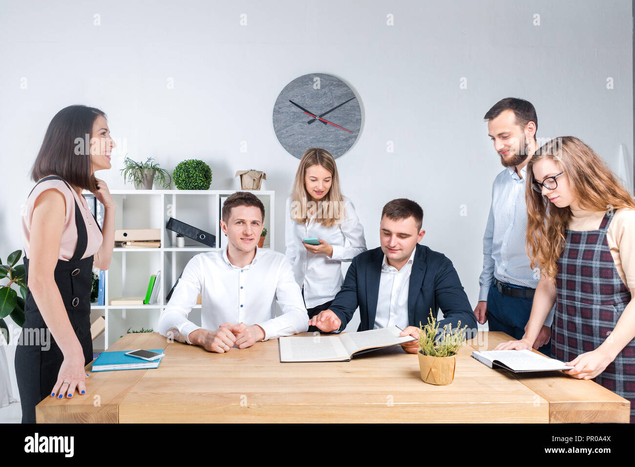 Theme is business and teamwork. A group of young Caucasian people ...