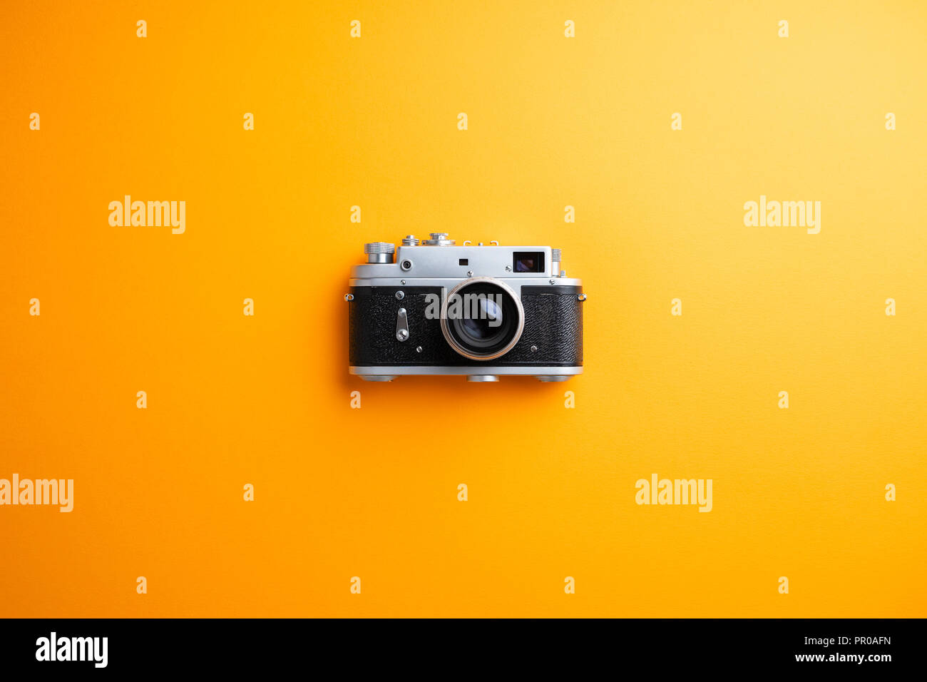 Vintage camera over orange background Stock Photo