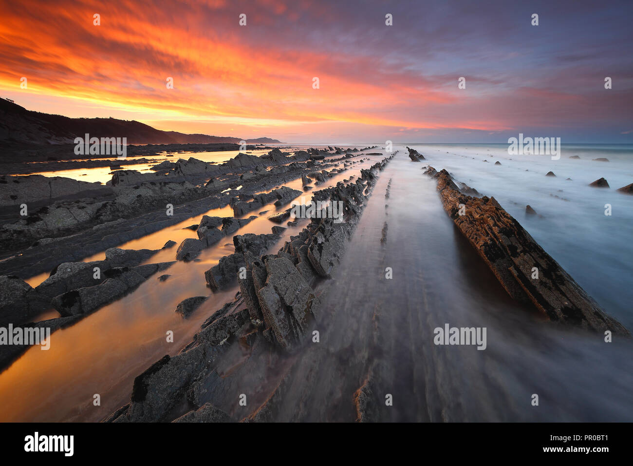 Amazing sunset over the flysch of Sakoneta beach (Guipuzcoa, Basque Country) Stock Photo