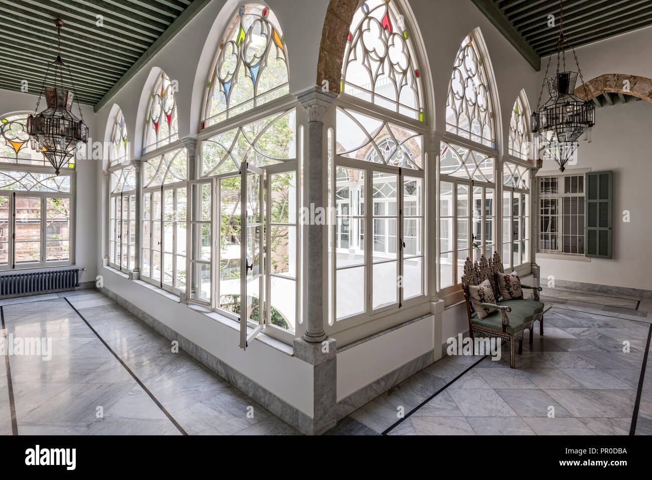 Nine glazed arches form gallery above courtyard. Stock Photo