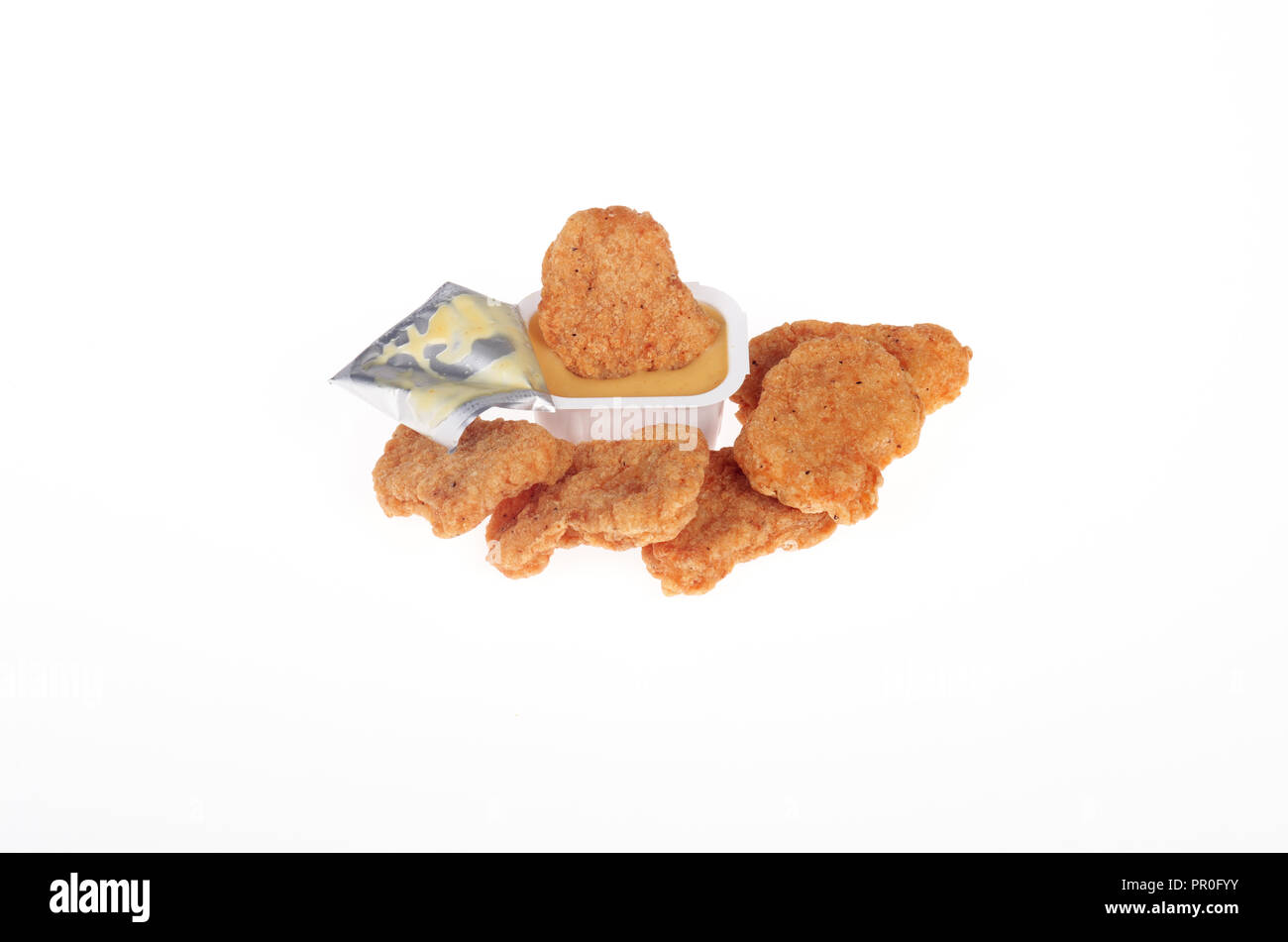Chicken nuggets with honey mustard dipping sauce on white background Stock Photo
