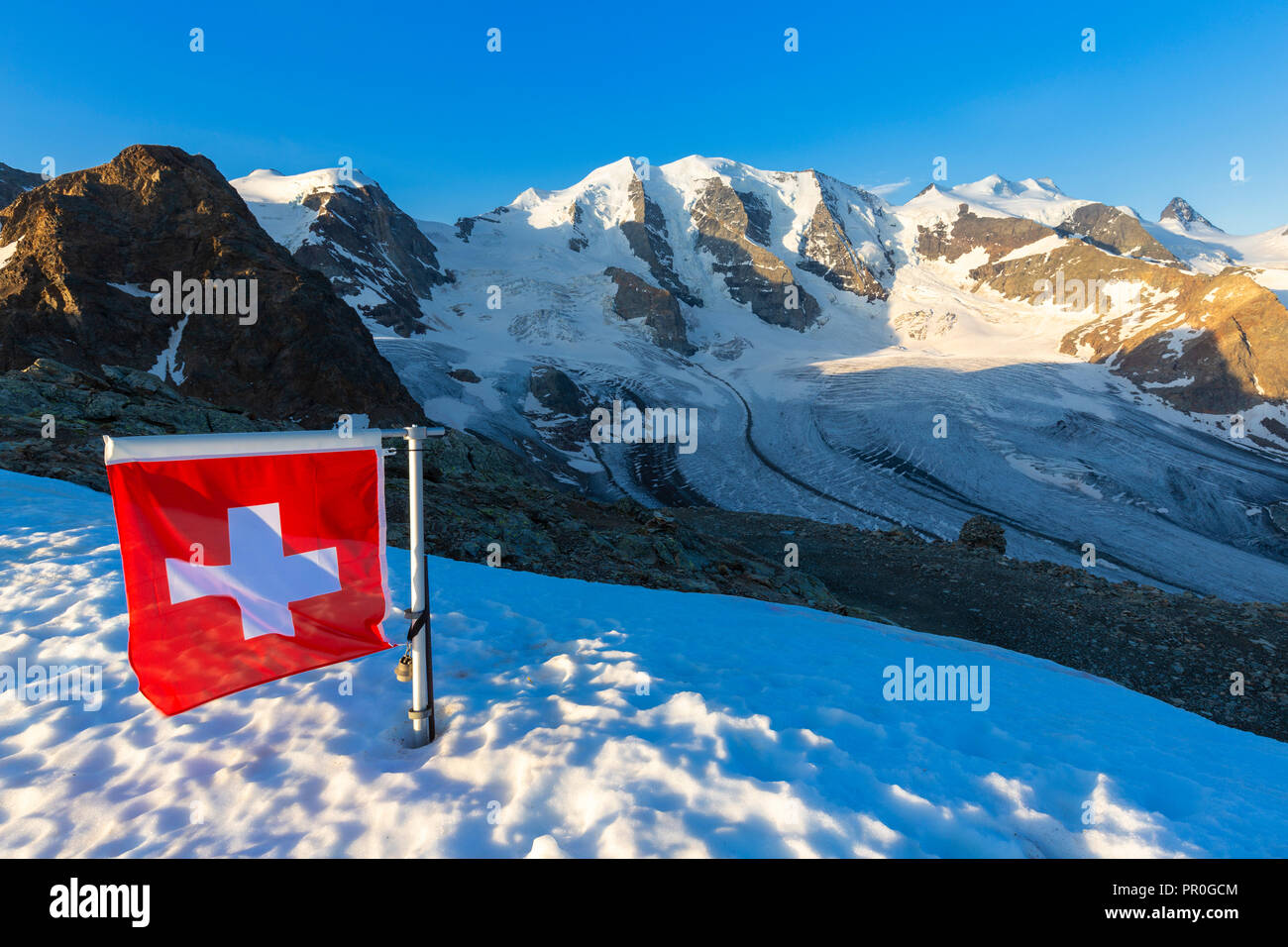 Swiss flag with Palu and Vedret Pers Glacier, Diavolezza Refuge, Bernina Pass, Engadine, Graubunden, Switzerland, Europe Stock Photo
