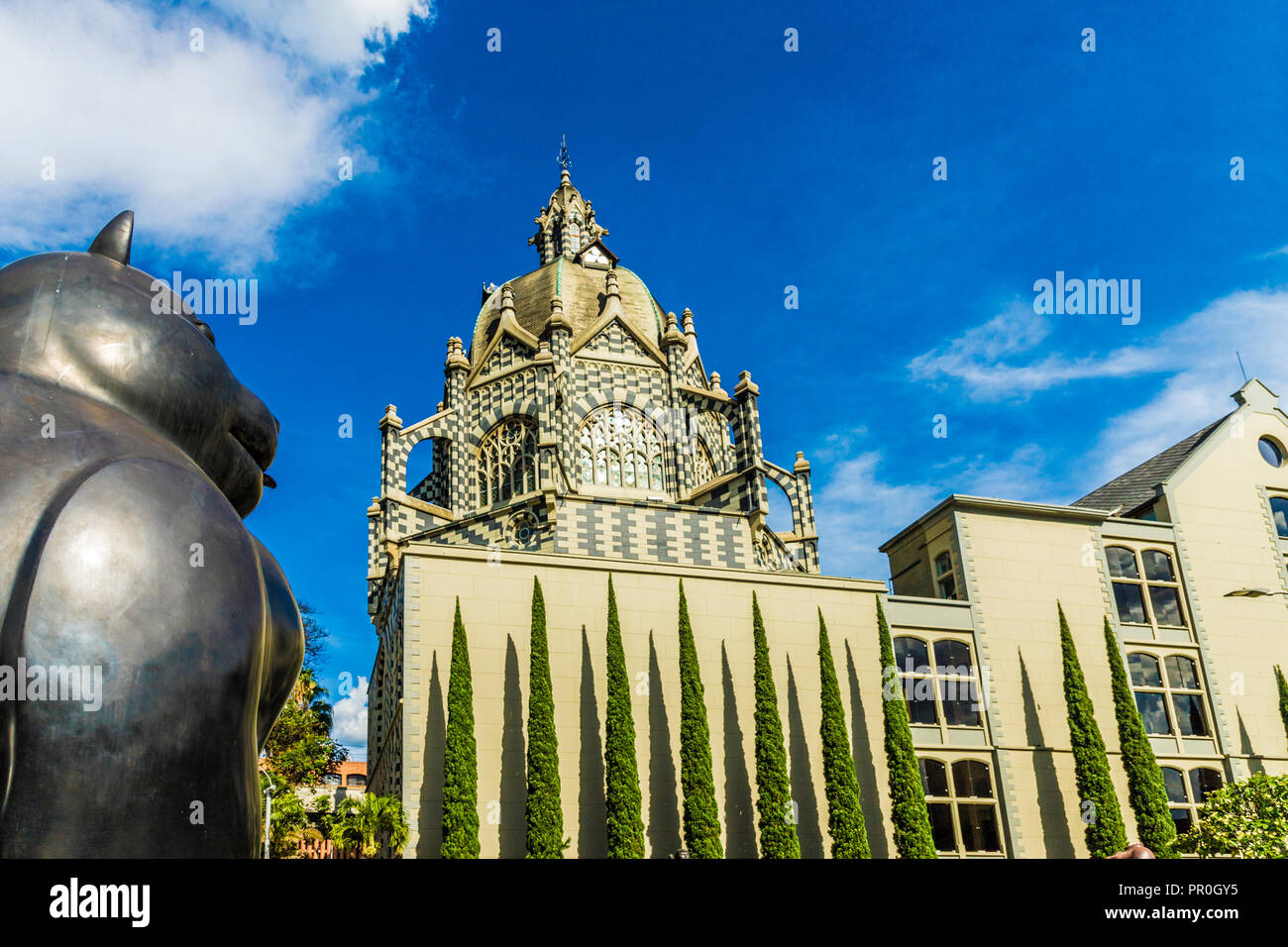 A view of the Rafael Uribe Uribe Palace of Culture with the Fernando Botero statue Gato (Cat) in the foreground, Medellin, Colombia, South America Stock Photo