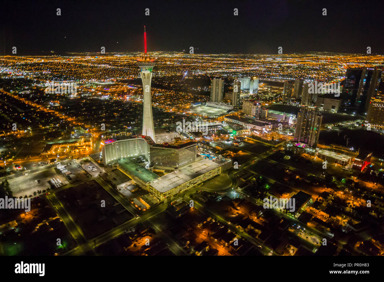 View of Las Vegas and Stratosphere Tower from helicopter at night, Las Vegas, Nevada, United States of America, North America Stock Photo