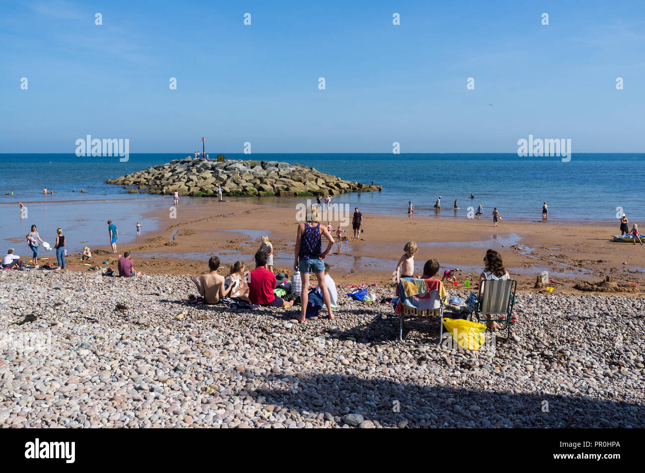 Sidmouth, Devon. A summer beach scene with blue skies and many local people and holiday makers. Stock Photo