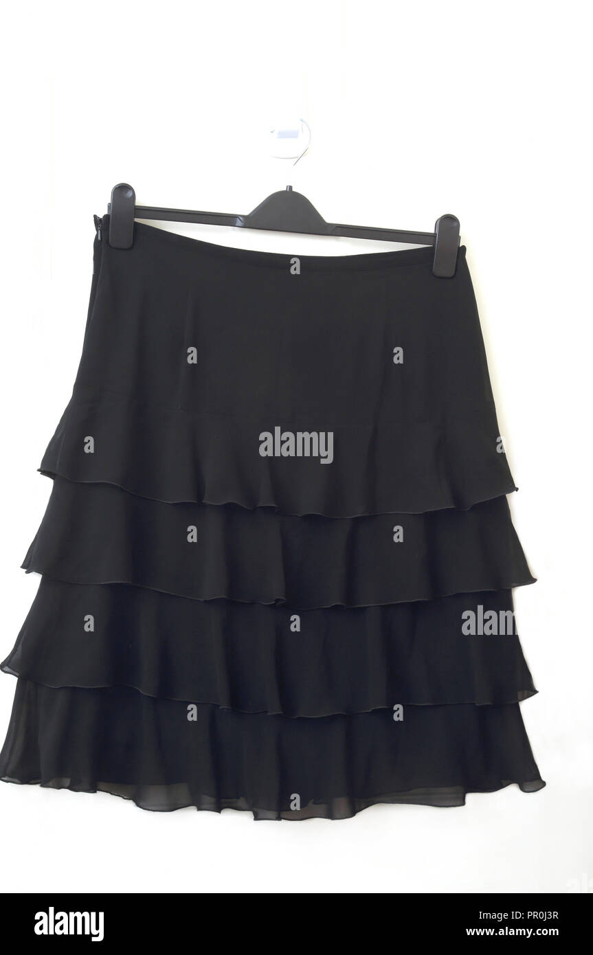 Black Knee Length Frill Skirt hanging on door Stock Photo