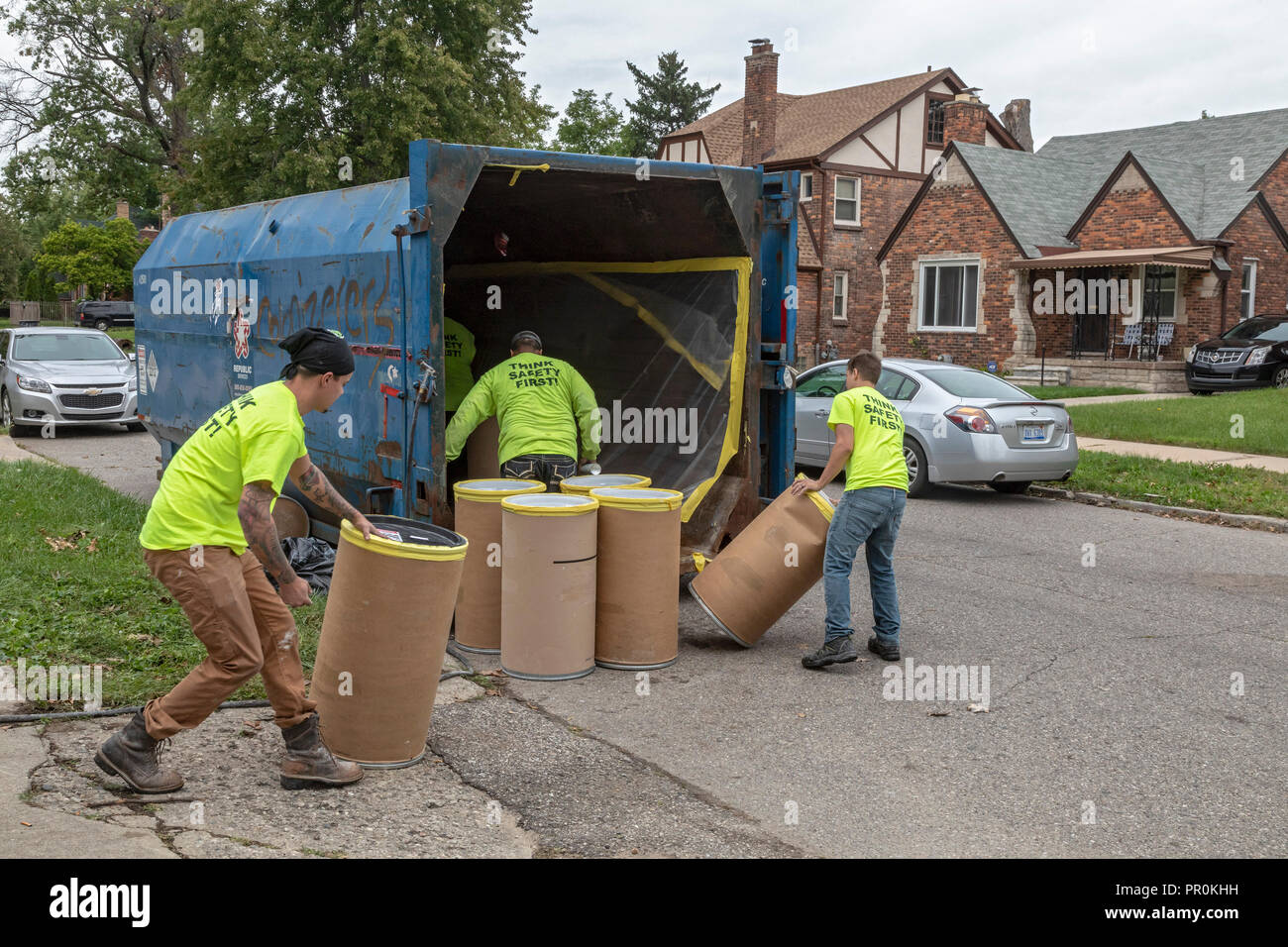 Detroit, Michigan - Workers remove barrels of asbestos from a vacant house in the Morningside neighborhood. Stock Photo
