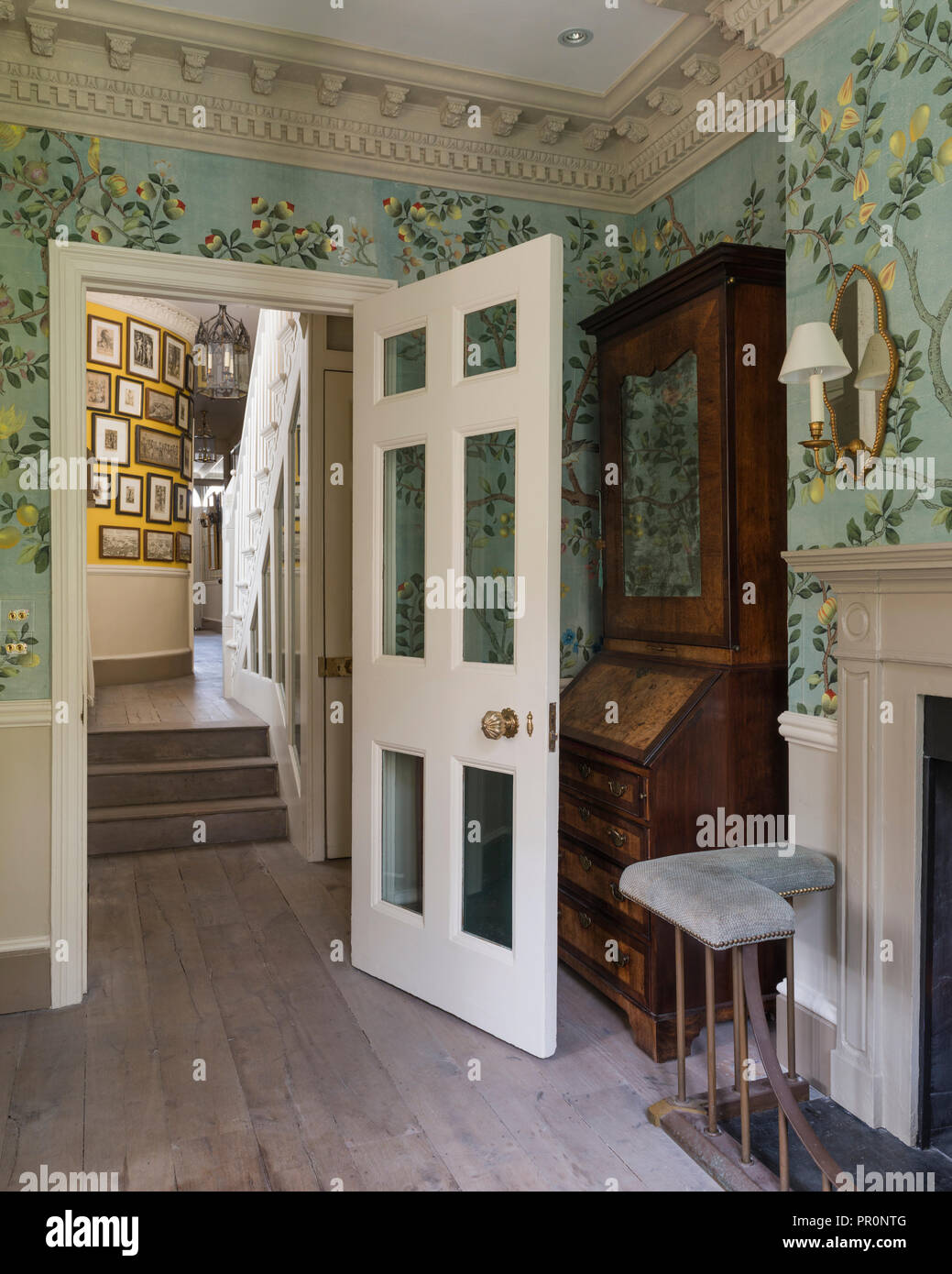 Antique cabinet behind doorway in split level London home Stock Photo