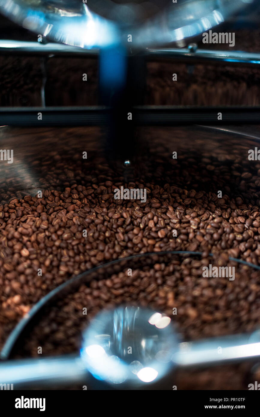 Coffee bean roasting machine. Beans are mixing close up shot Stock