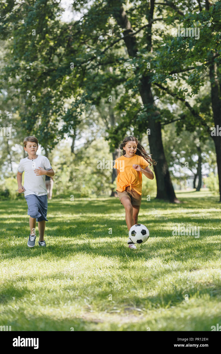 cute happy kids playing with soccer ball in park Stock Photo - Alamy