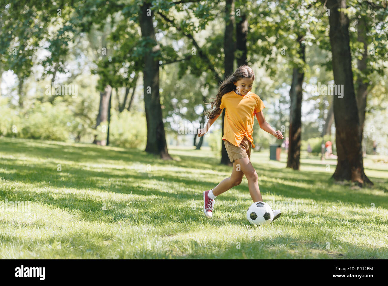 beautiful happy child playing with soccer ball in park Stock Photo - Alamy