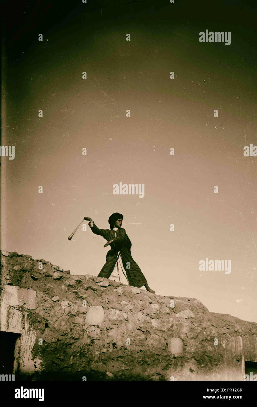 Shepherd boy slinging. 1900, Middle East, Israel and/or Palestine Stock Photo