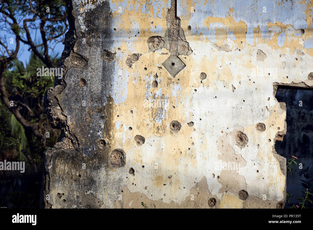Old concrete building, covered in holes from machine gun fire from Sri Lankan civil war in Jaffna, Sri Lanka Stock Photo