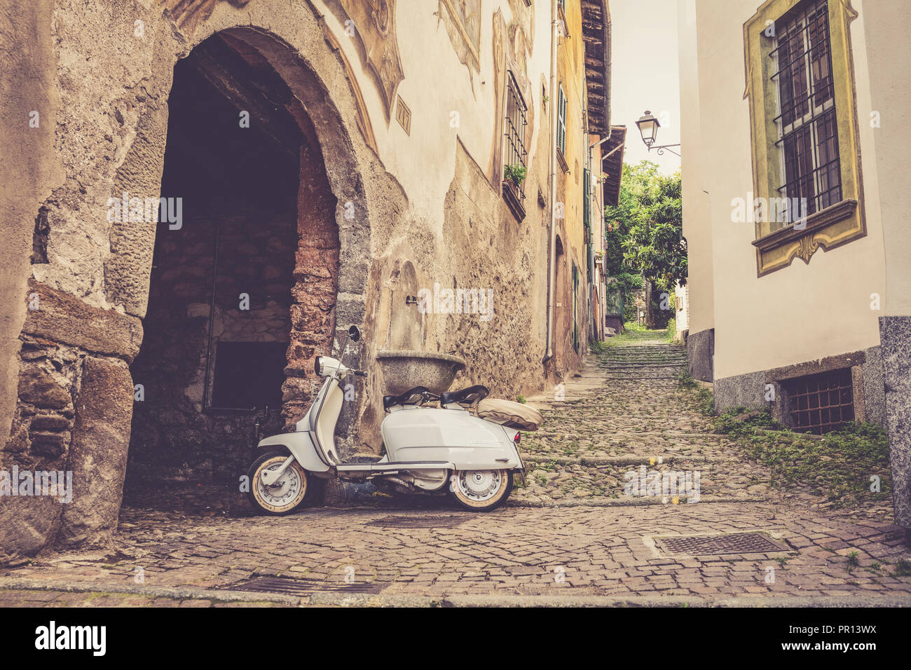 White Lambretta Innocenti scooter in the old alley, Morbegno, province of Sondrio, Valtellina, Lombardy, Italy, Europe Stock Photo