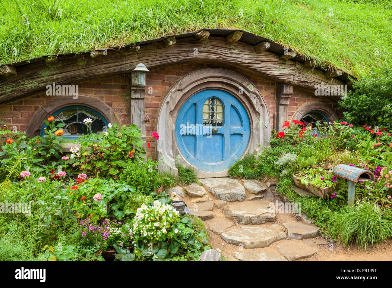 Hobbiton, wooden doors of Hobbit holes in the film set fictional village of Hobbiton, Matamata, North Island, New Zealand, Pacific Stock Photo