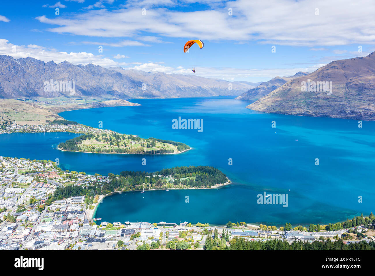 Aerial view of Queenstown, paraglider, Lake Wakatipu and The Remarkables mountains, Queenstown, Otago, South Island, New Zealand, Pacific Stock Photo