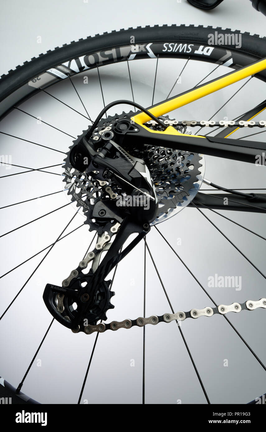 Rear wheel of a mountain bike with rear derailleur, chain and gear cogs. Stock Photo