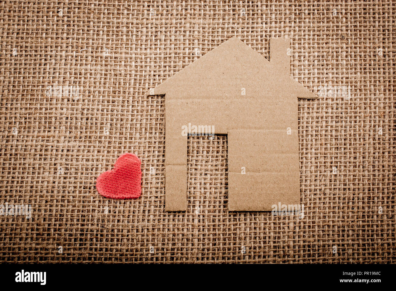 Heart shape beside paper house with a canvas background Stock Photo - Alamy