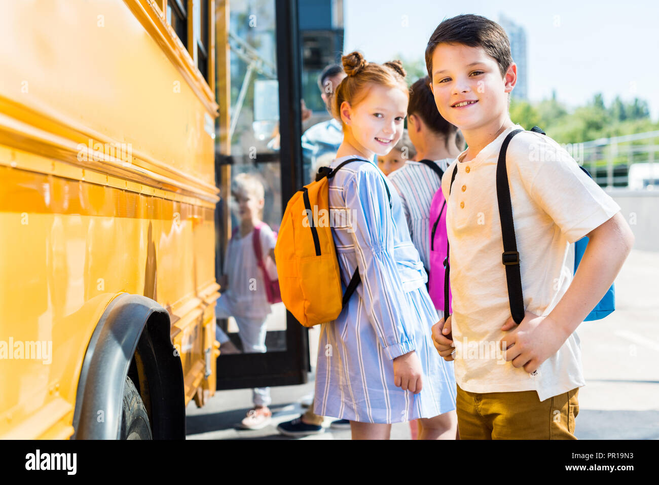 smiling little pupils entering school bus with classmates Stock Photo ...