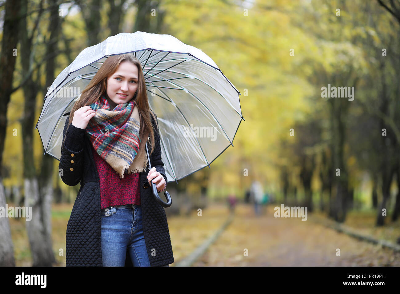 Young girl on a walk in the autumn park Stock Photo - Alamy
