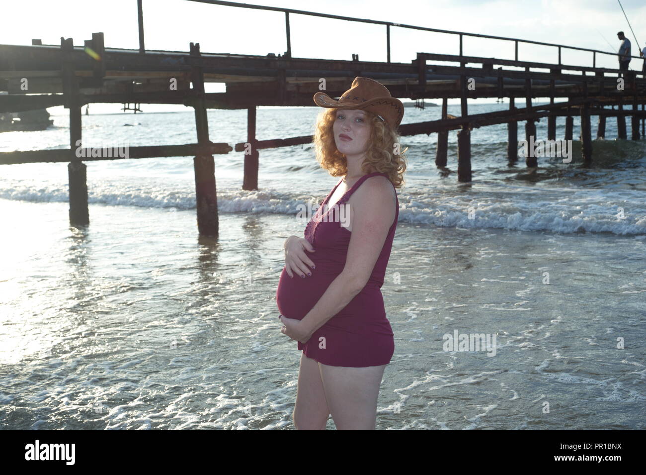 pregnancy woman play on shore, coastal sea Stock Photo