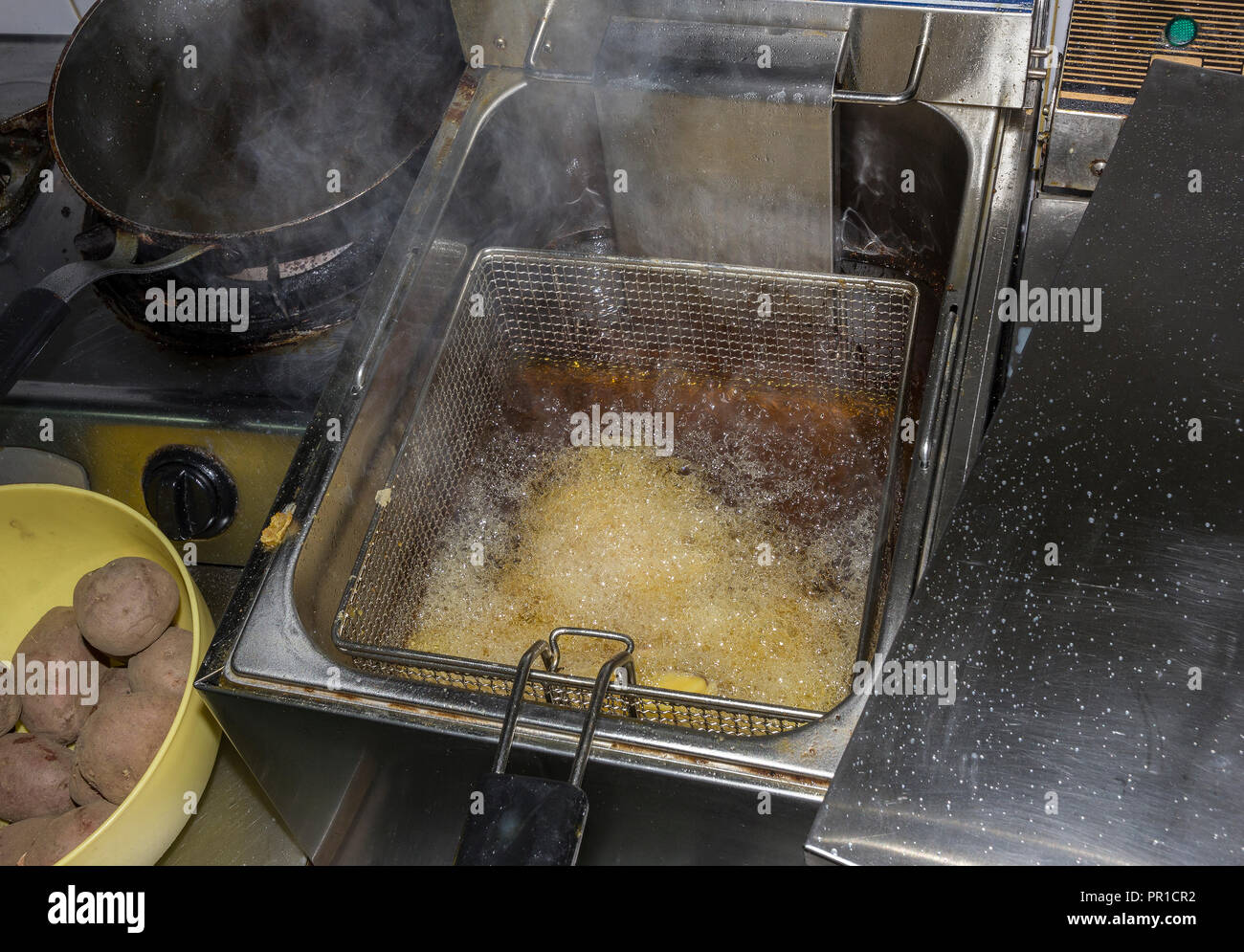 fryer for potatoes with fries with boiling oil. Concept fast food restaurant,  kitchen equipment Stock Photo