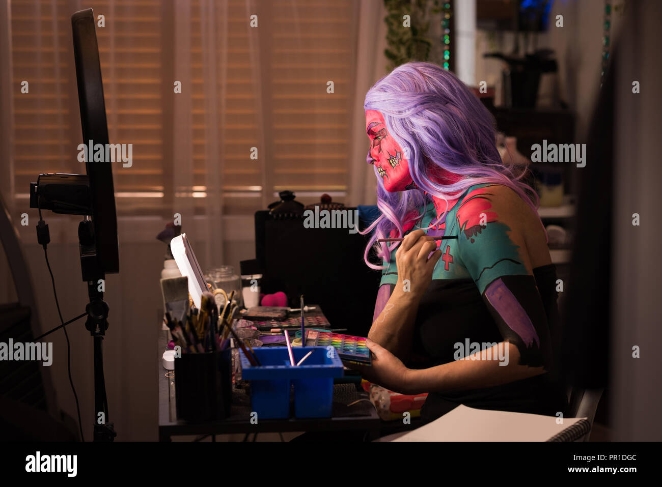 Woman painting her body Stock Photo
