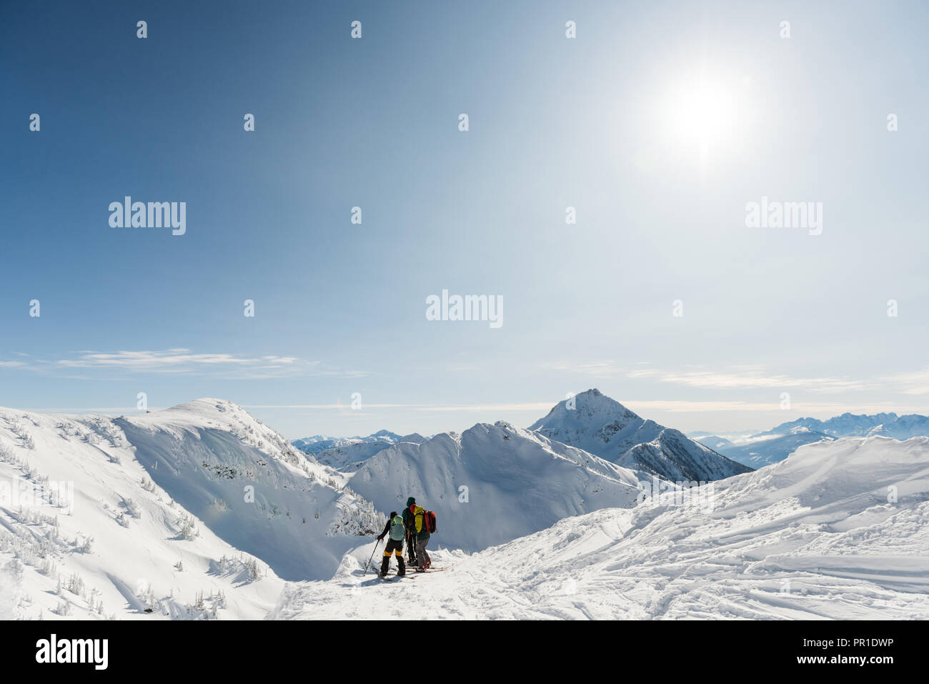Group of skiers walking on a snowy mountain Stock Photo