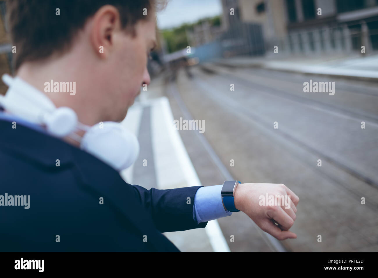 Businessman checking time in his smartwatch Stock Photo