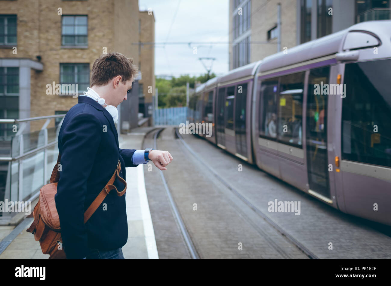 Businessman checking time in his smartwatch Stock Photo
