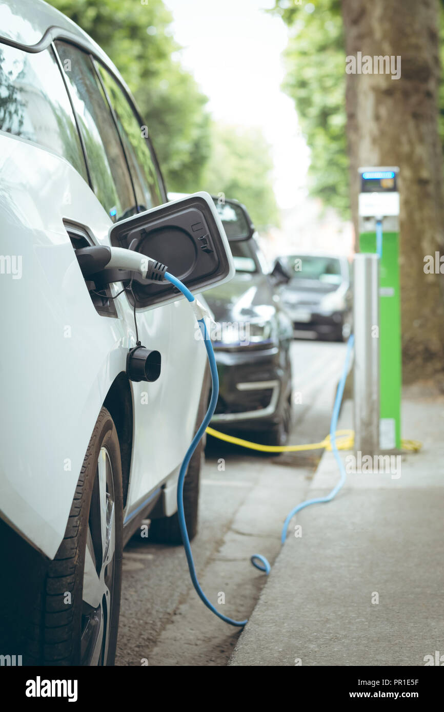 Electric car charging at charging station Stock Photo