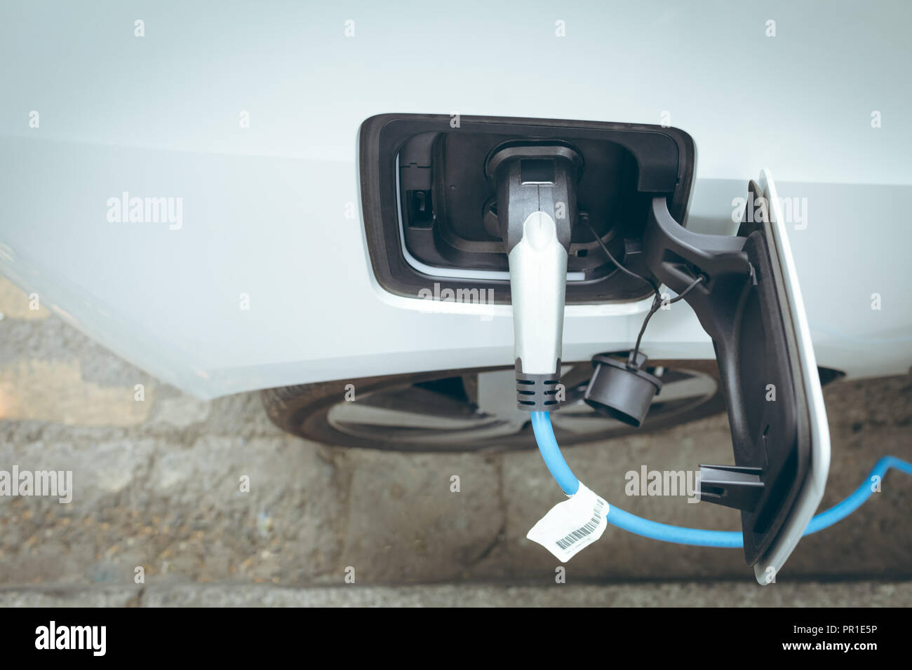 Electric car charging at charging station Stock Photo Alamy
