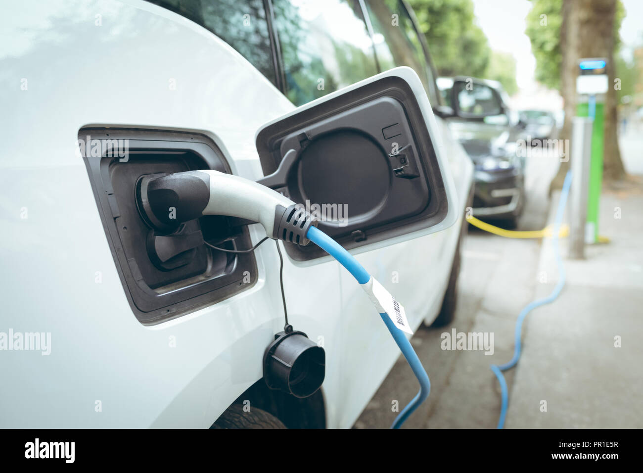 Electric car charging at charging station Stock Photo