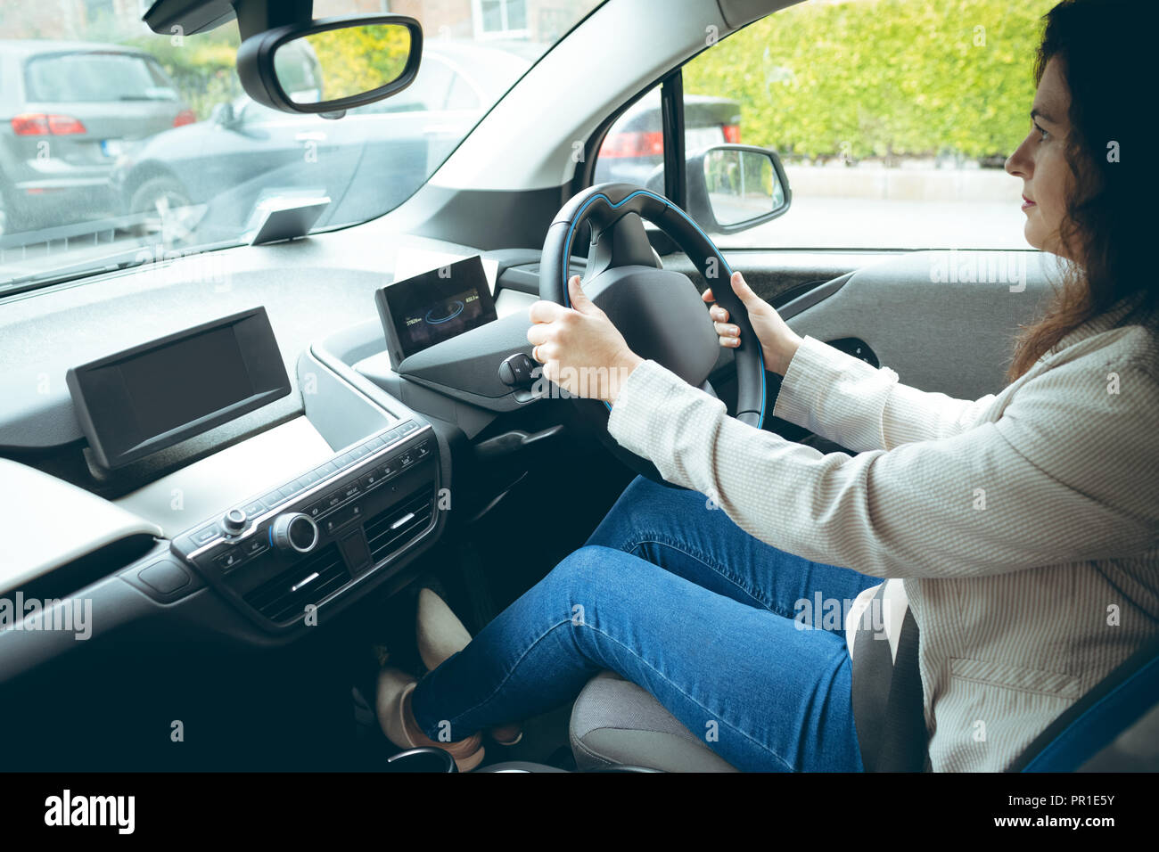 Businesswoman driving car in city Stock Photo