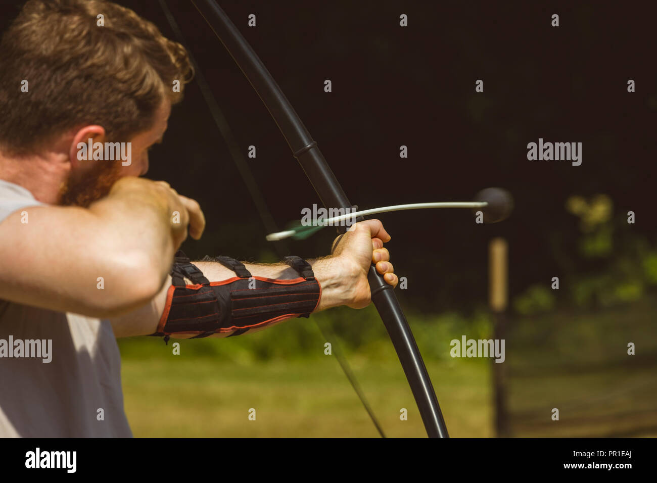 Man practicing archery at boot camp Stock Photo
