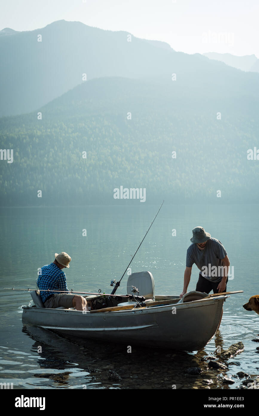 Two fishermen preparing for fishing at countryside Stock Photo