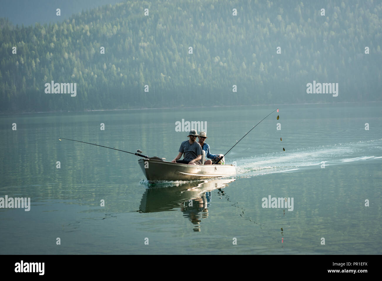 Two fishermen fishing in the river Stock Photo