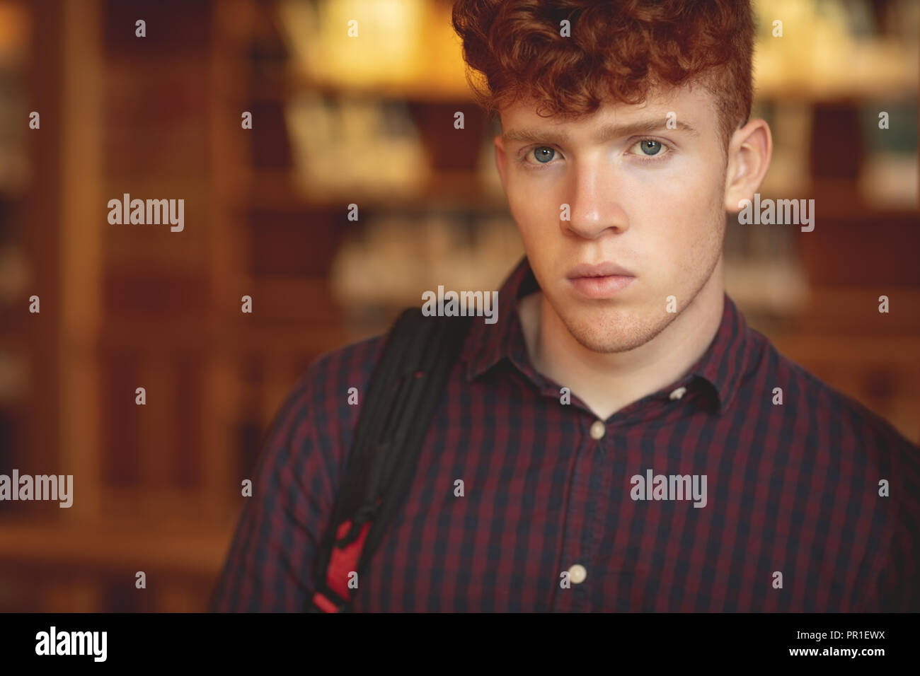 College student looking at camera in library Stock Photo