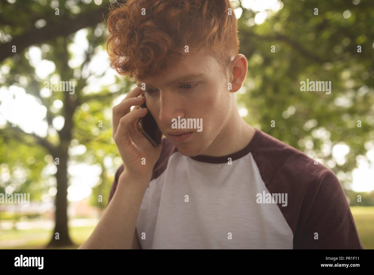 College student talking on mobile phone in campus Stock Photo