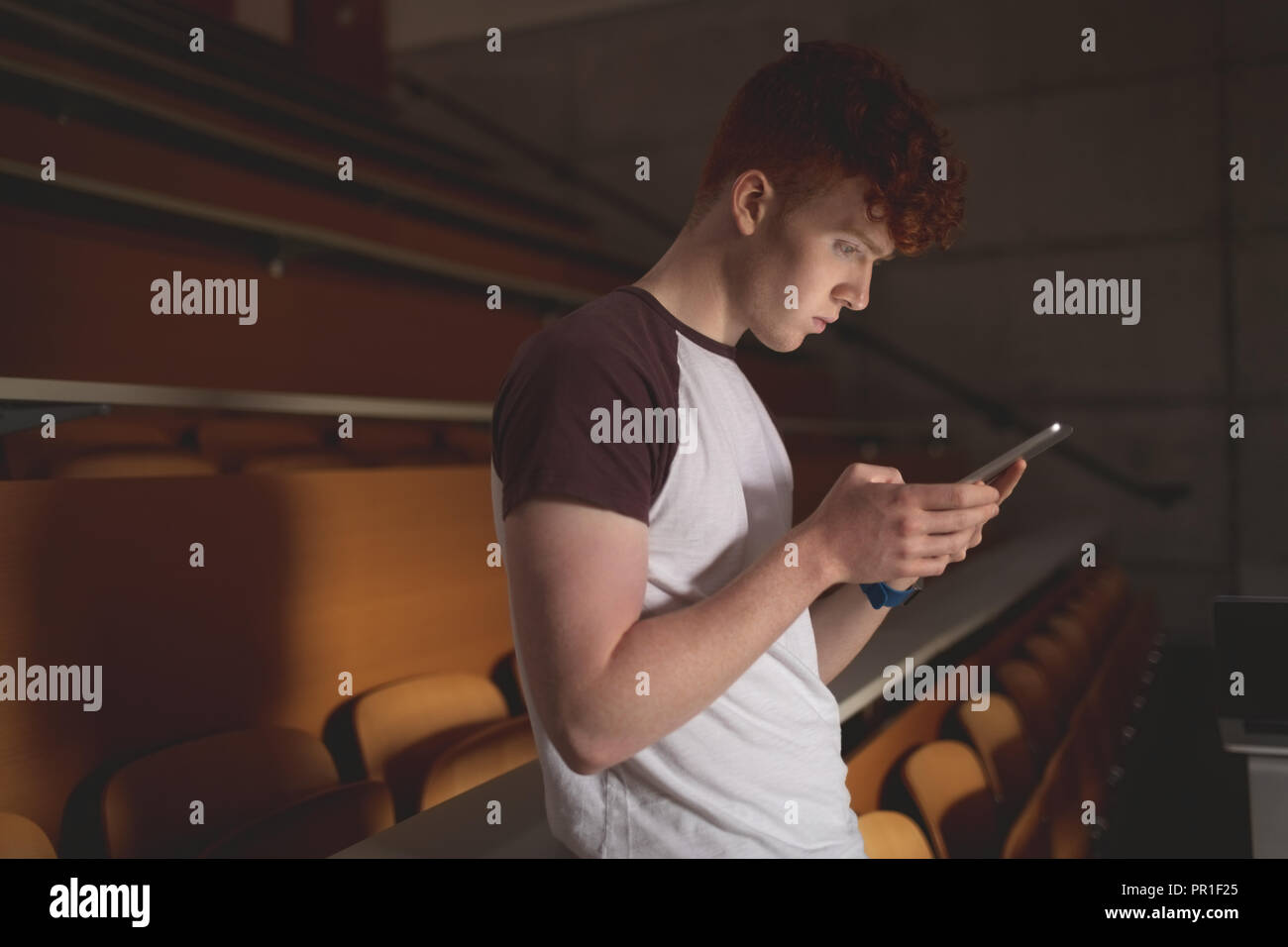College student using digital tablet in classroom Stock Photo