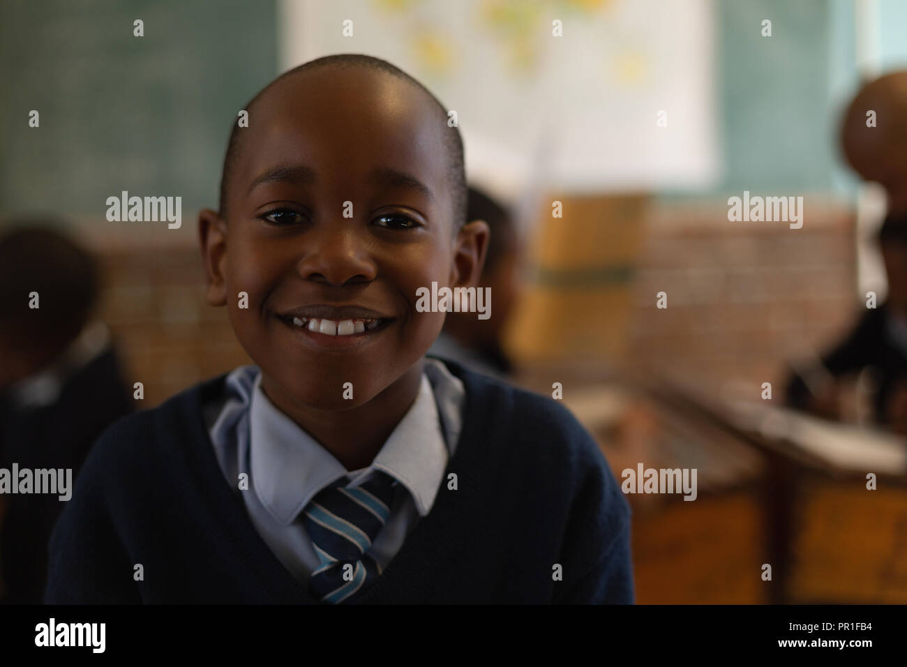 Schoolboy standing in the classroom Stock Photo