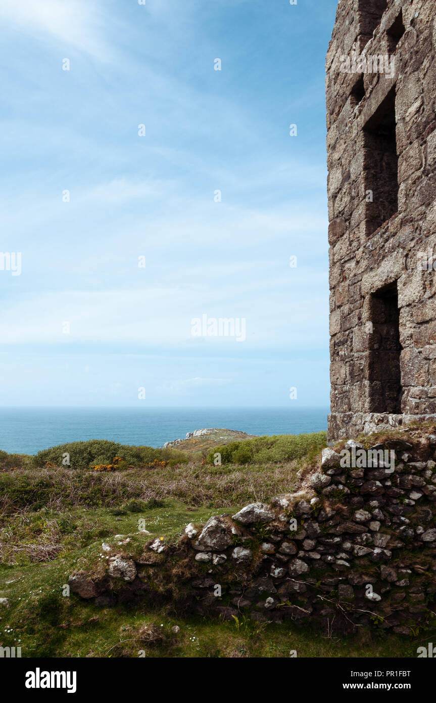 Looking out to sea past the steam pumping engine house of Carn Galver tin mine in Cornwall. Other names Wheal Rose, Rosemergy. Stock Photo