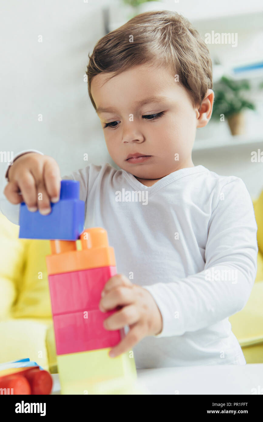 toddler playing with colorful constructor blocks at home Stock Photo ...
